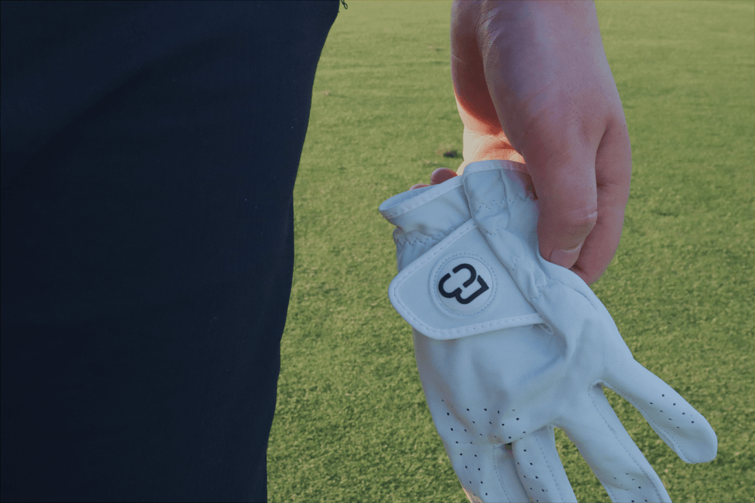 Gloved hand gripping on the golf course